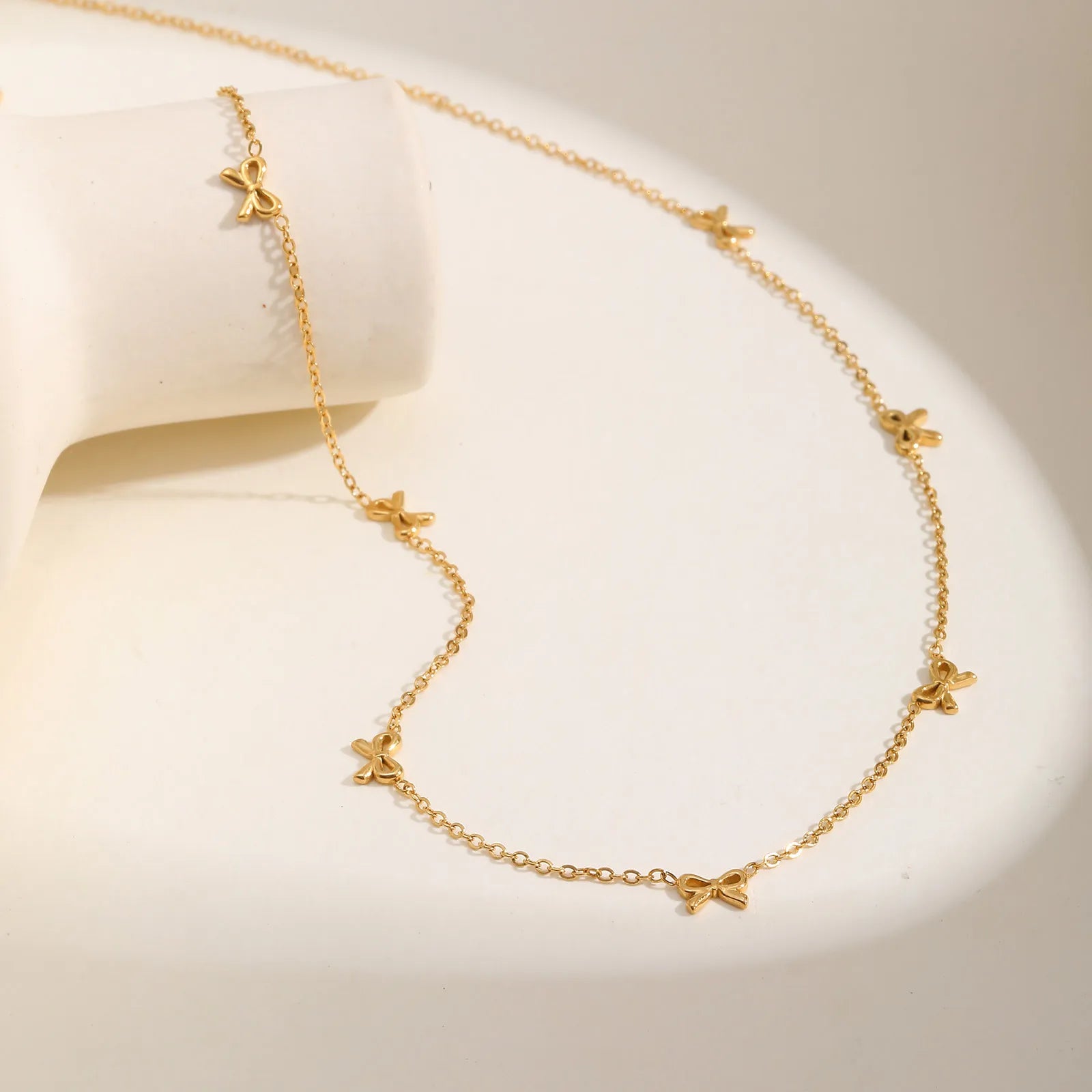 Stainless steel bow choker necklace, minimalist style.