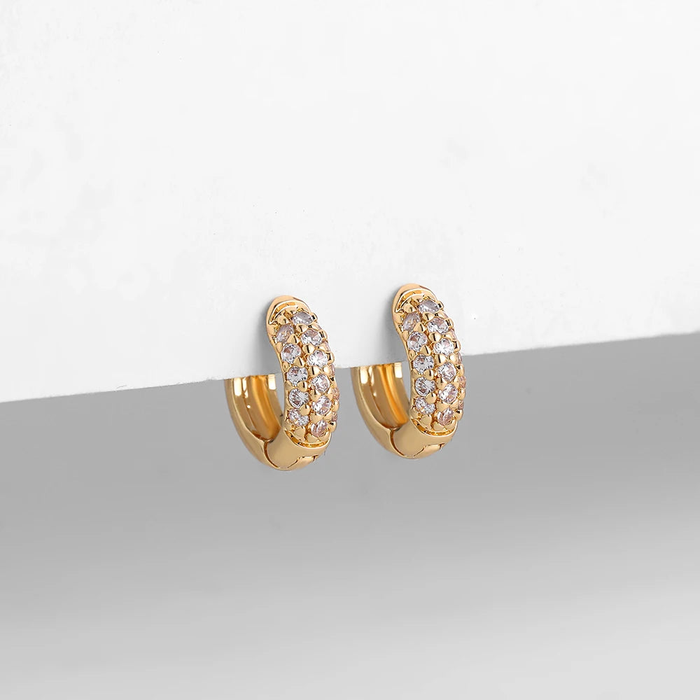 Thin gold-plated huggie hoop earrings with CZ/zircon embellishments, minimalist style.