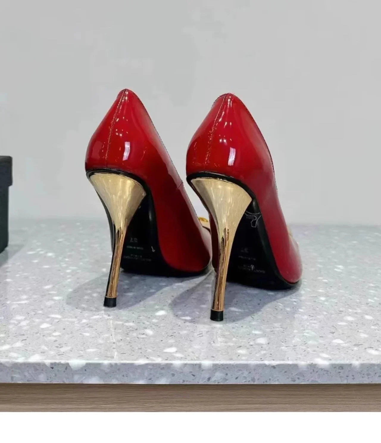 Square-toed patent leather pumps with stiletto heels and gem-studded decorations