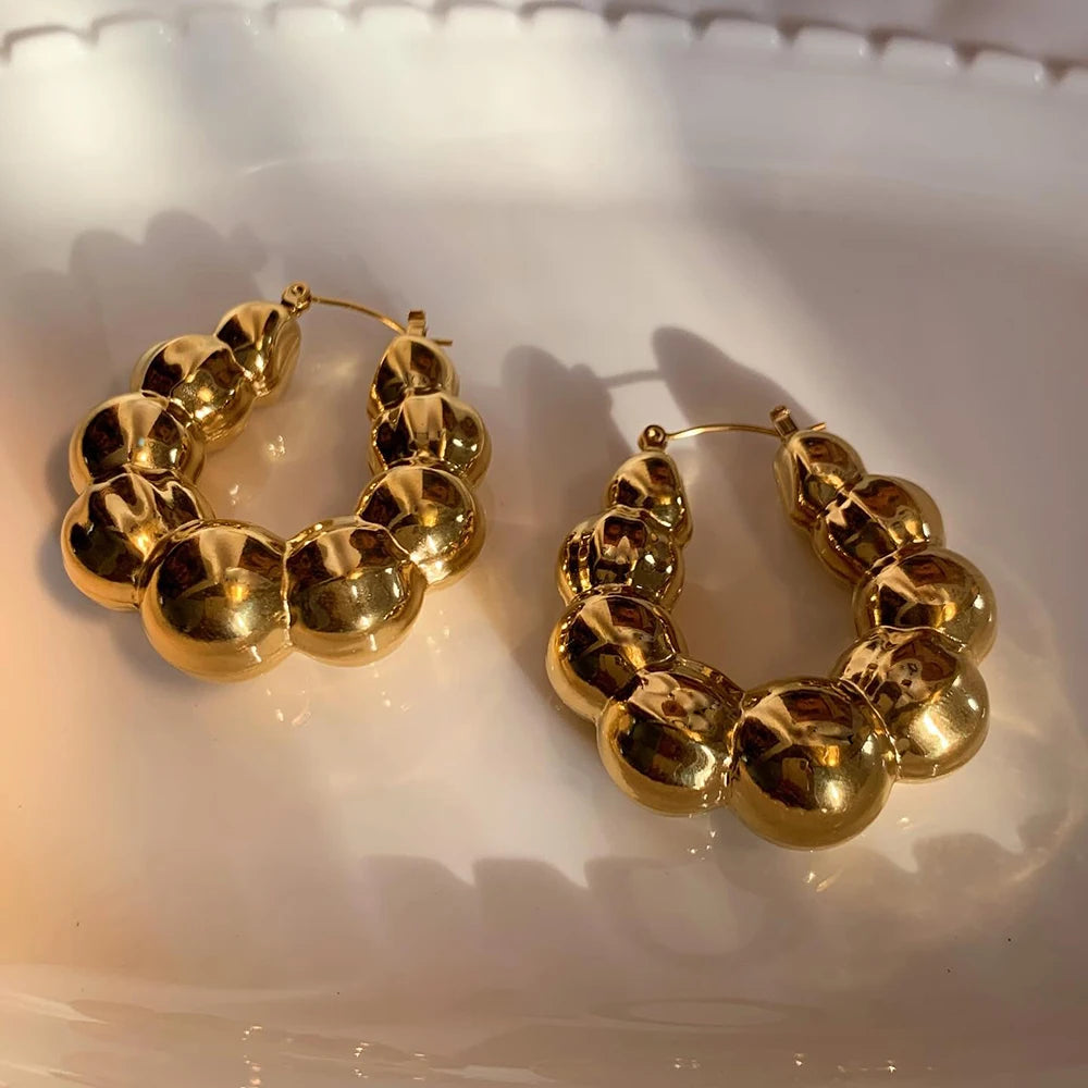 Large thick hoop earrings, gold plated stainless steel, lightweight, vintage punk style.