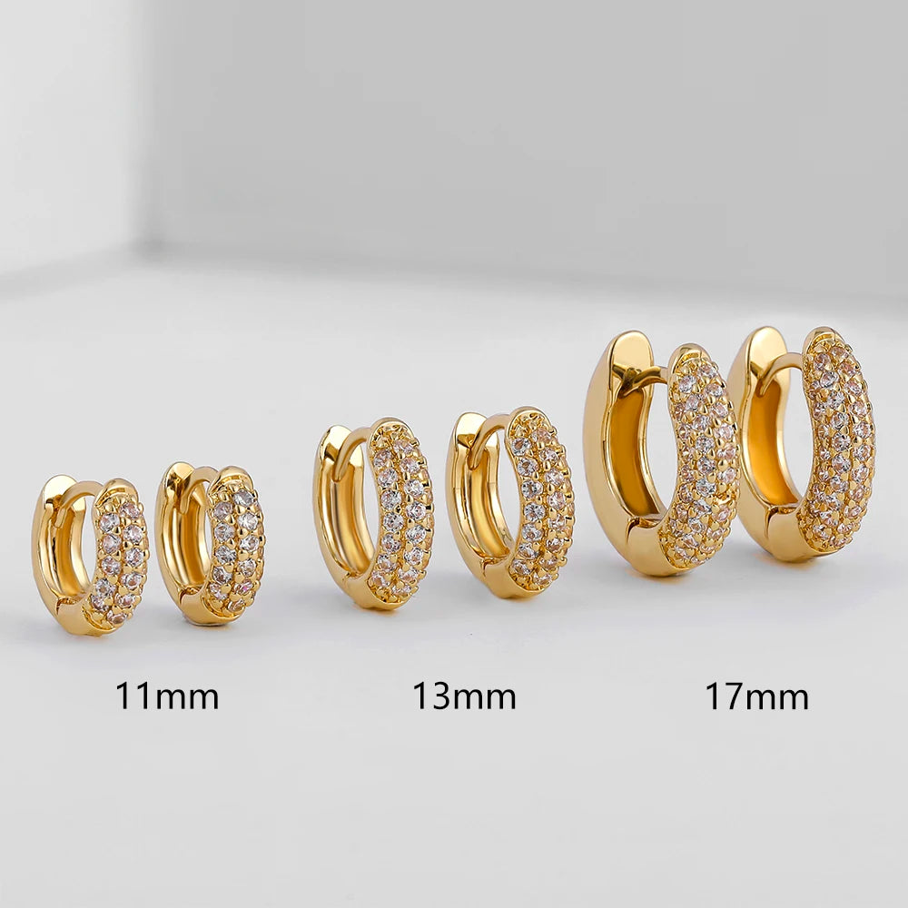 Thin gold-plated huggie hoop earrings with CZ/zircon embellishments, minimalist style.