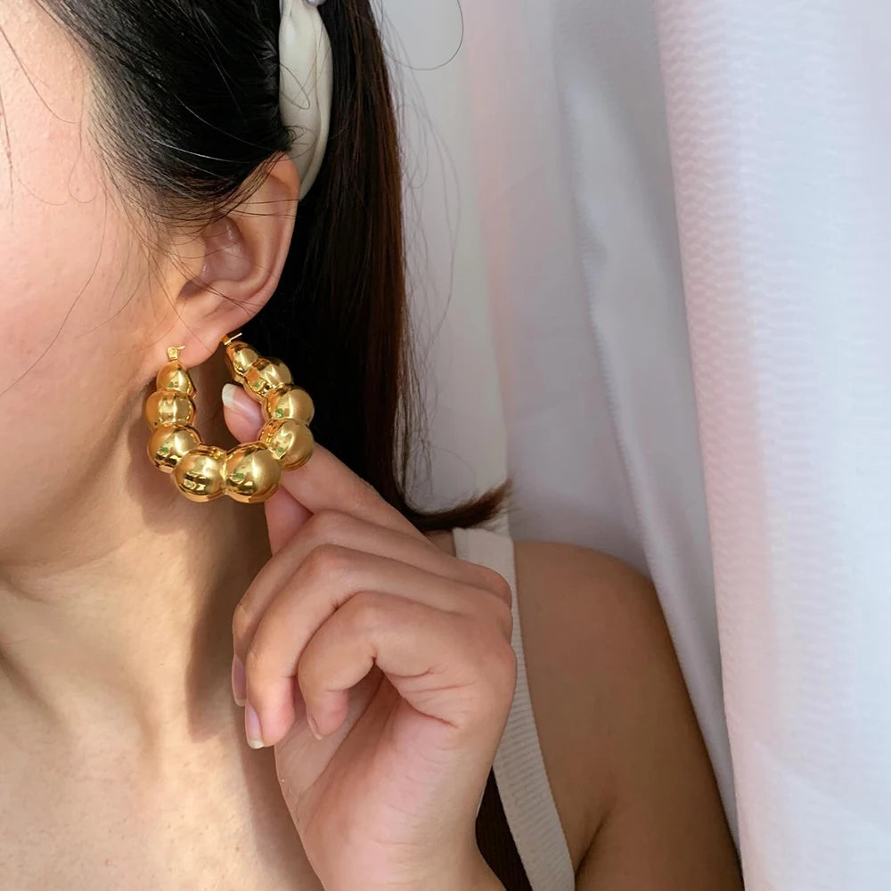 Large thick hoop earrings, gold plated stainless steel, lightweight, vintage punk style.