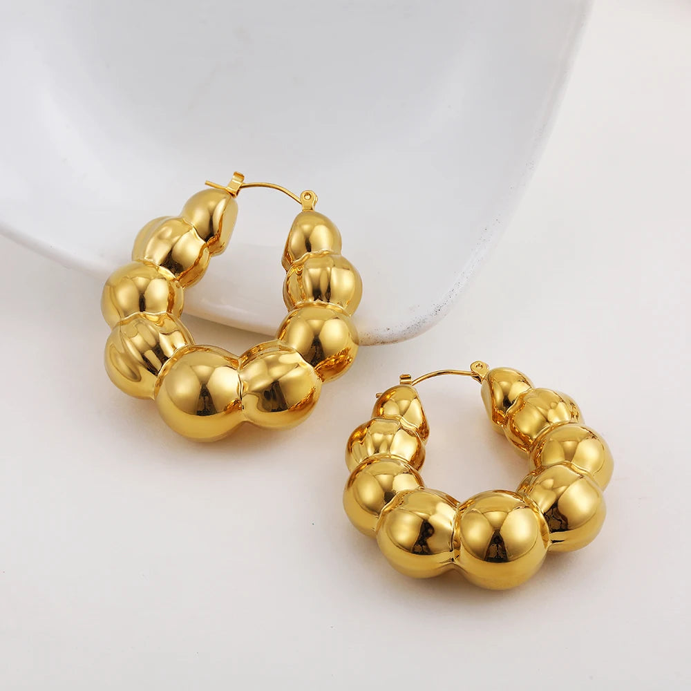 Large thick hoop earrings, gold plated stainless steel, lightweight, vintage punk style.